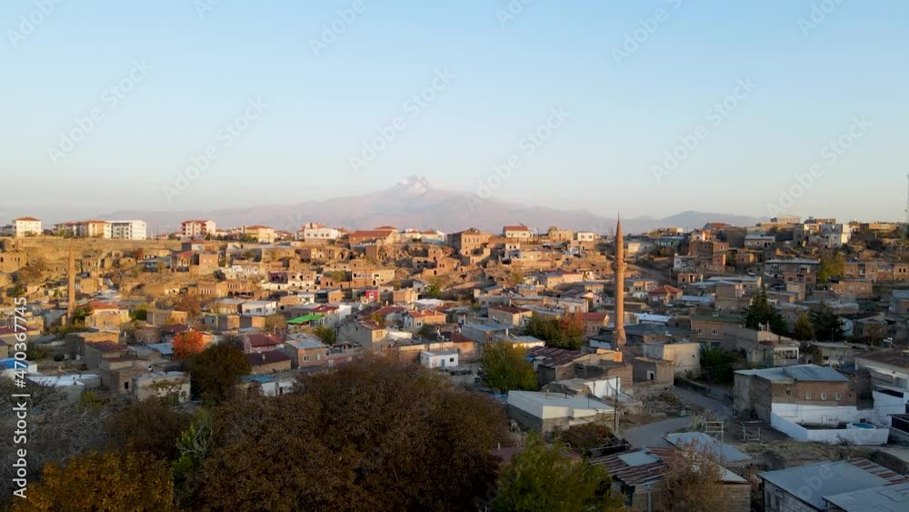 A historical muslim town. Azan time and mosque minarets. A snowy mountain landscape in the background. Very nice drone footage video A historical muslim town. Azan time and mosque minarets. A snowy mountain landscape in the background. Very nice drone footage video