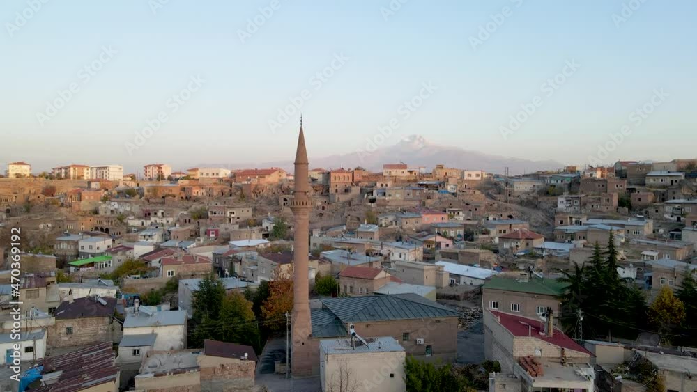 A historical muslim town. Azan time and mosque minarets. A snowy mountain landscape in the background. Very nice drone footage video A historical muslim town. Azan time and mosque minarets. A snowy mountain landscape in the background. Very nice drone footage video