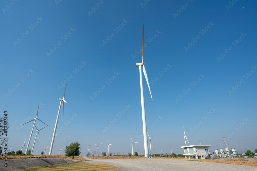 Wind turbines and solar panels in a big green field Wind turbines and solar panels in a big green field