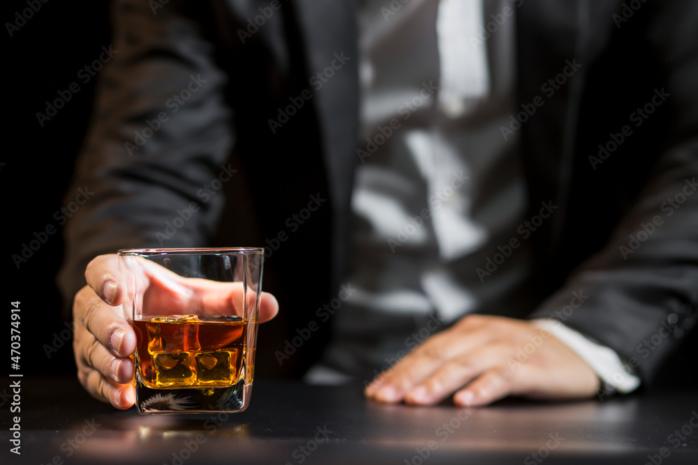 Closeup businessmen holding a glass of whiskey Closeup businessmen holding a glass of whiskey