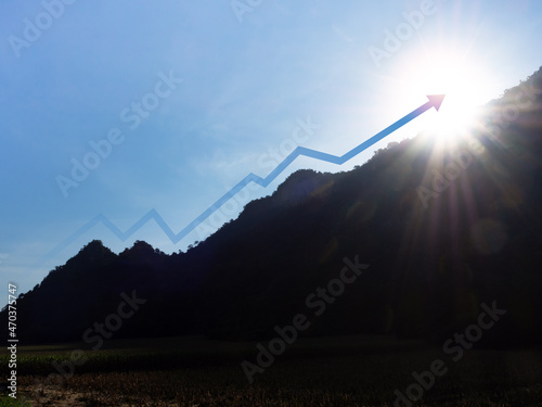 The rising up arrow on the mountain with sunlight from behind. Leadership and success Concept. The arrow flew up along the hillside shape like a business chart with increased profit.