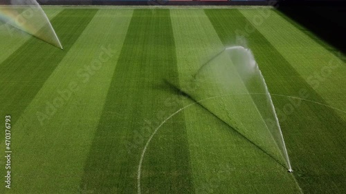Watering football field before professional football game, lawn care, irrigation of grass before soccer match concept. 4k high quality cinematic hdr footage 