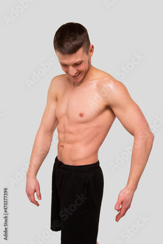 Man Showing ABS. Muscle man Posing. Strong Body Concept. Topless Sport man Bodybuilder. Six Pack Spotsman. Fitness Posing © Alex