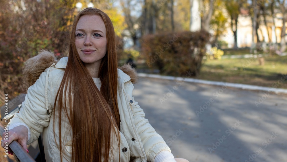 stylish and beautiful, red-haired girl with long hair smiles with a happy smile stylish and beautiful, red-haired girl with long hair smiles with a happy smile