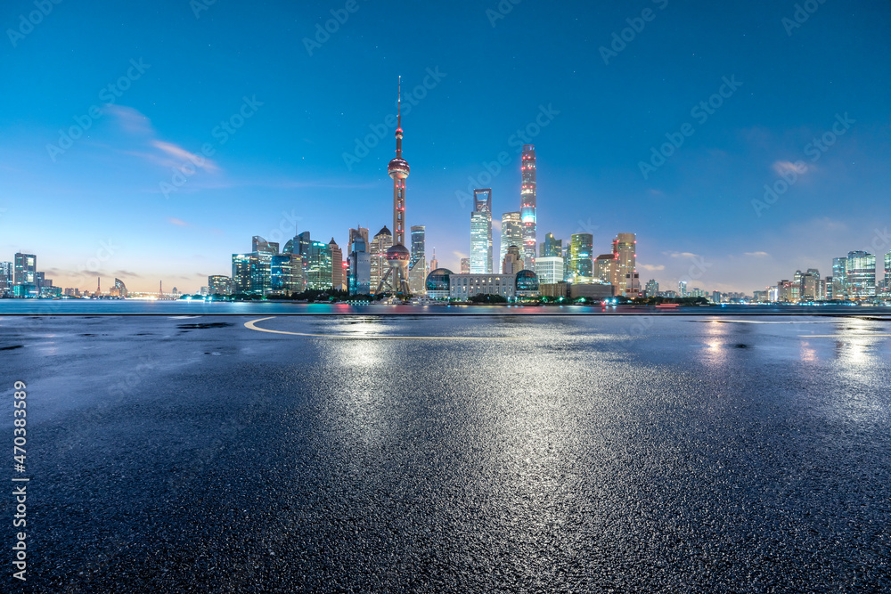Empty asphalt road and modern city skyline with buildings in Shanghai at sunrise