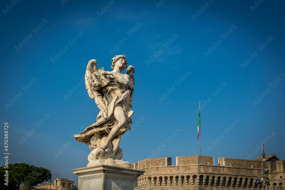 Angel with the Superscription on Ponte Sant'Angelo (Bridge of Hadrian) in front of Castel Sant'Angelo (Castle of the Holy Angel)  in Parco Adriano, Rome, Italy