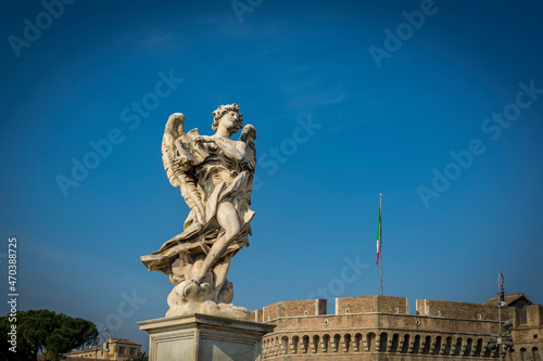 Angel with the Superscription on Ponte Sant'Angelo (Bridge of Hadrian) in front of Castel Sant'Angelo (Castle of the Holy Angel) in Parco Adriano, Rome, Italy