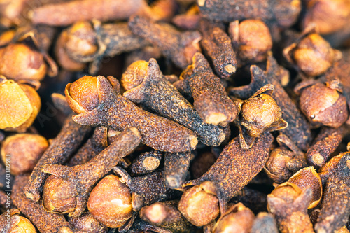 Clove dried spices. Cloves background. Pile of dried cloves in macro shot.