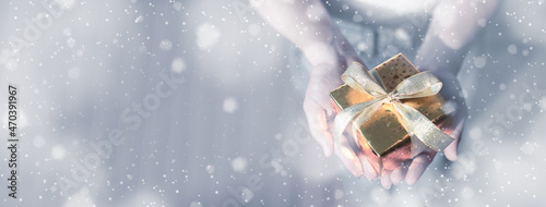 Wallpaper Mural Close up shot Female hands holding gift box. silver concept. Christmas, new year, birthday concept. Festive background with snow and bokeh. Magic fairy tale. Shallow depth of field with focus on box. Torontodigital.ca