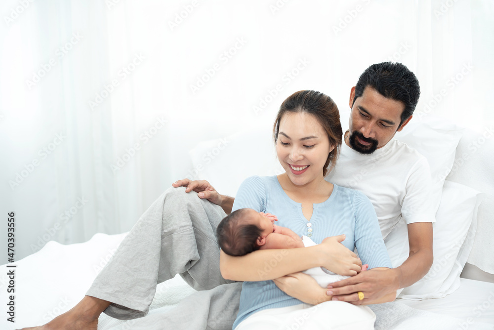 Parent and children relaxing together. Portrait of a young family with mother, father, son and daugther. Parents having happy time, welcoming newborn. Parent and children relaxing together. Portrait of a young family with mother, father, son and daugther. Parents having happy time, welcoming newborn.