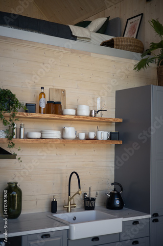 Barnhouse, Barn house kitchen interior. Wooden secluded house in the Scandinavian and Finland modern style with large windows. Kitchen shelves and dishes photo