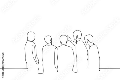 group of men looks at the wall at which one of them pokes his finger - one line drawing vector. concept male company listens to leader who points something with finger on the board