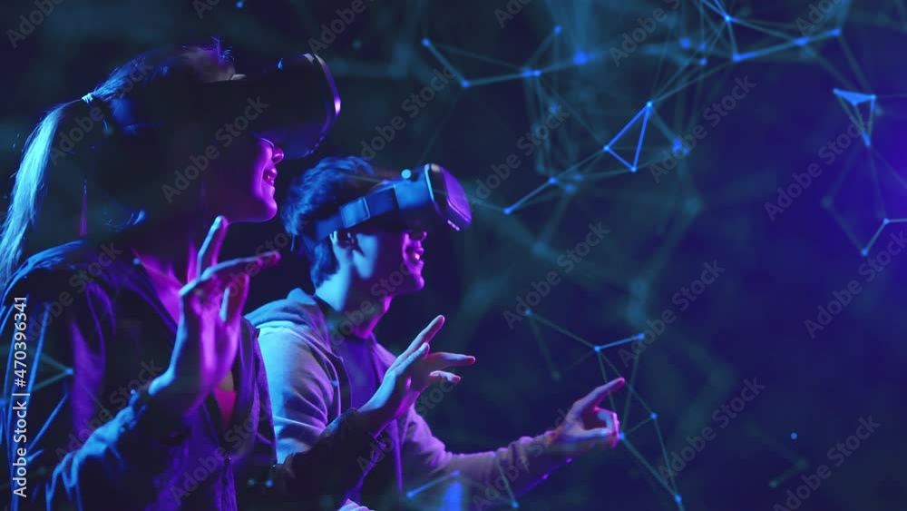 Metaverse VR virtual reality game playing, man and woman play metaverse virtual digital technology game control with VR goggle