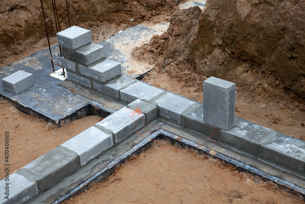 Bricklaying of foundation blocks for a new home. House construction concept