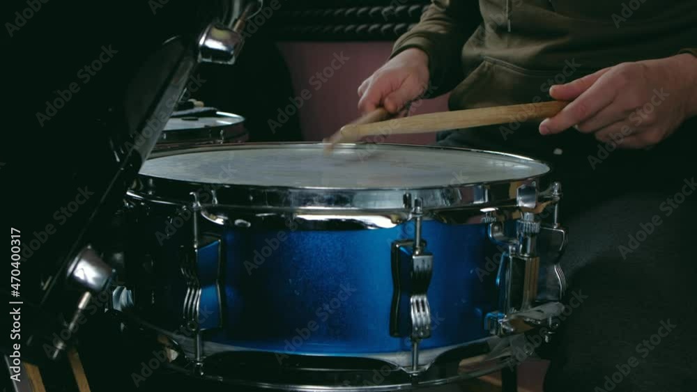 close up - the drummer plays with sticks on a snare drum, home lesson paradiddle training close up - the drummer plays with sticks on a snare drum, home lesson paradiddle training