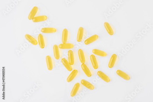 Overhead view of omega 3 capsule scattered on white background