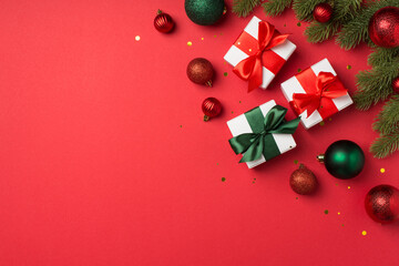 Top view photo of green and red christmas tree balls pine branches white gift boxes with ribbon bows and golden confetti on isolated red background with empty space