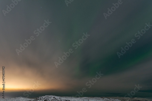 At night, fog and northern lights tundra and rocks in winter. © Moroshka