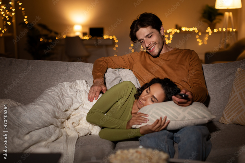 Boyfriend Looking At Sleeping Girlfriend Watching TV Indoors At Night Boyfriend Looking At Sleeping Girlfriend Watching TV Indoors At Night
