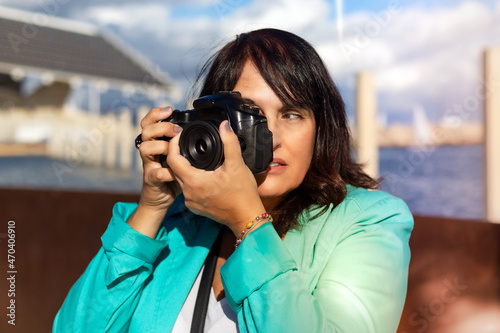 Woman taking a photo with her digital camera, Professional photographer shooting a picture.