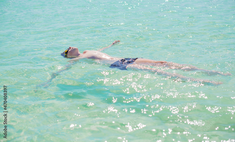 Teenage boy swimming in ocean, Children lifestyle. Enjoy the life, vacation concept
