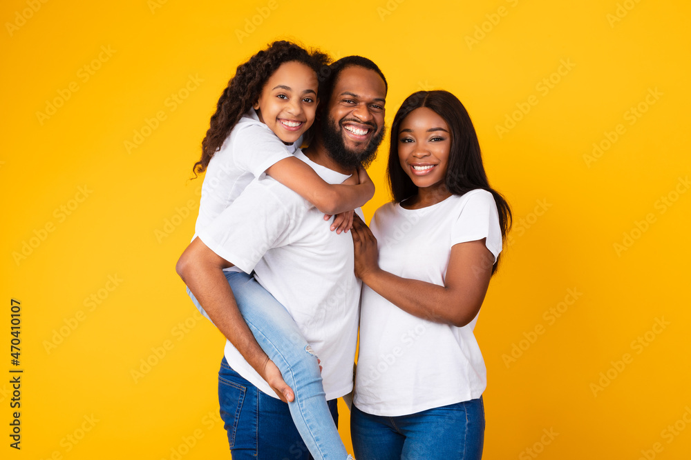 African American man posing with wife and smiling daughter African American man posing with wife and smiling daughter