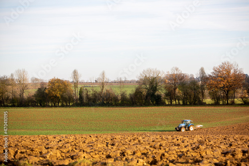 tractor with plow in agricultutal field near namur in belgian ardennes photo