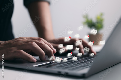 Businessman hand using Laptop computer with email icon, Email and newsletter concept