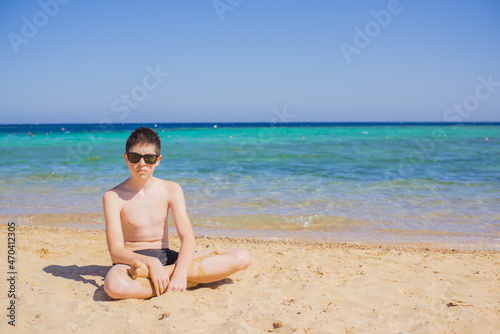 Teenage boy with a bad mood at sea, Children lifestyle. psychology concept