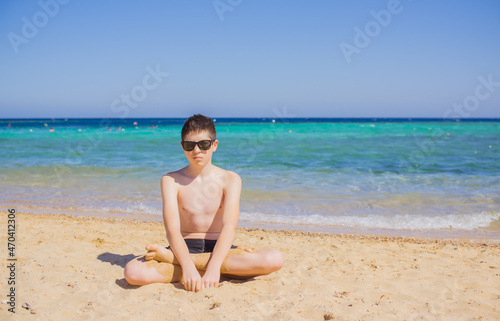 Teenage boy with a bad mood at sea, Children lifestyle. psychology concept