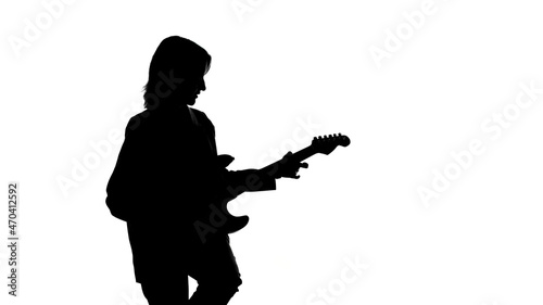 Photo of woman's silhouette with bass guitar on isolated white background