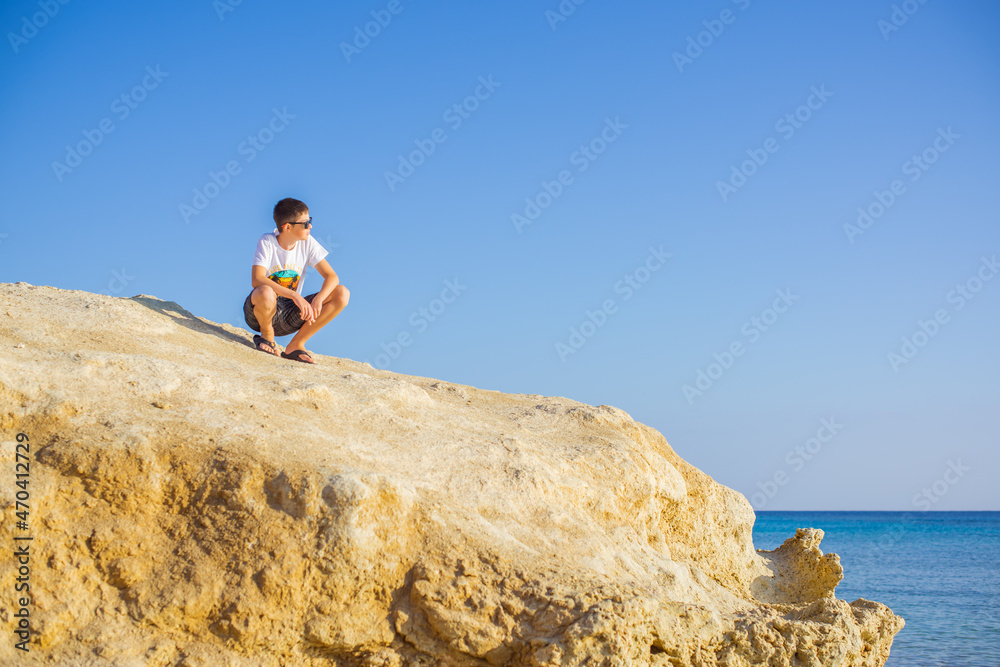 Teenage boy at sea, Children lifestyle. Enjoy the life, vacation concept Teenage boy at sea, Children lifestyle. Enjoy the life, vacation concept