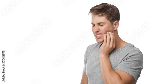 Obraz na plátně Despaired millennial european man suffering from toothache, press hand to jaw, s