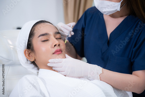 young Asian woman making cosmetology treatment skin injection  Mesotherapy of face beauty care