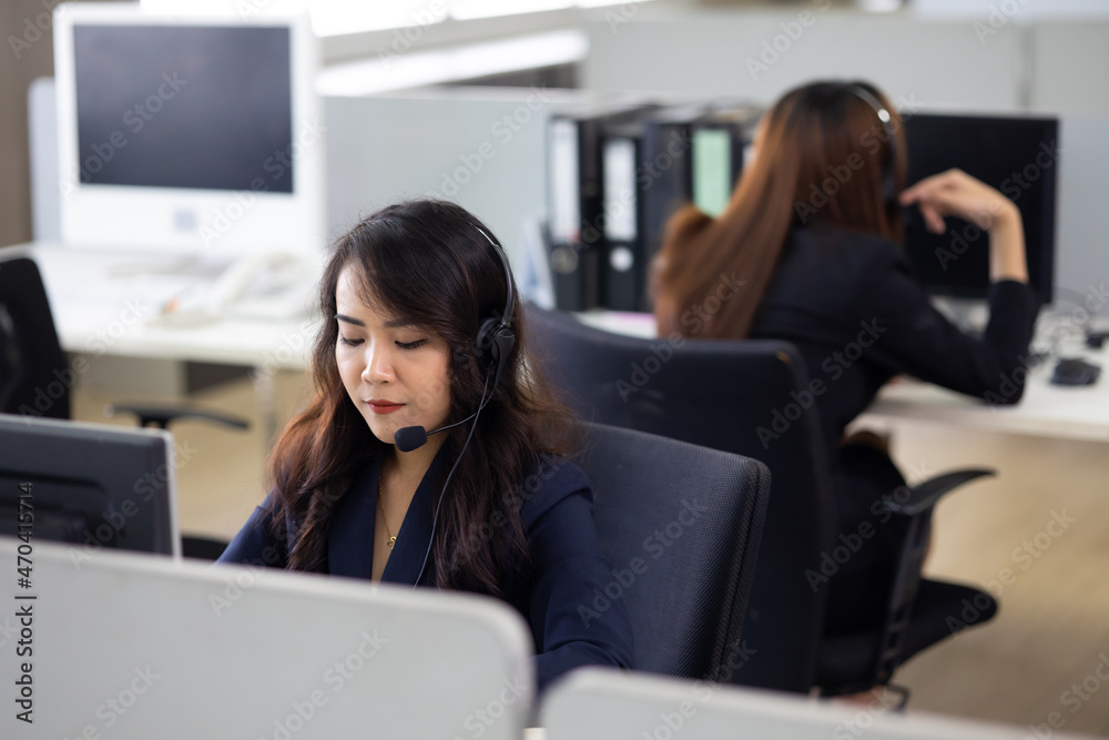 Attractive business Asian woman in headsets and business team working with desktop computer at home office. telemarketing customer service agents