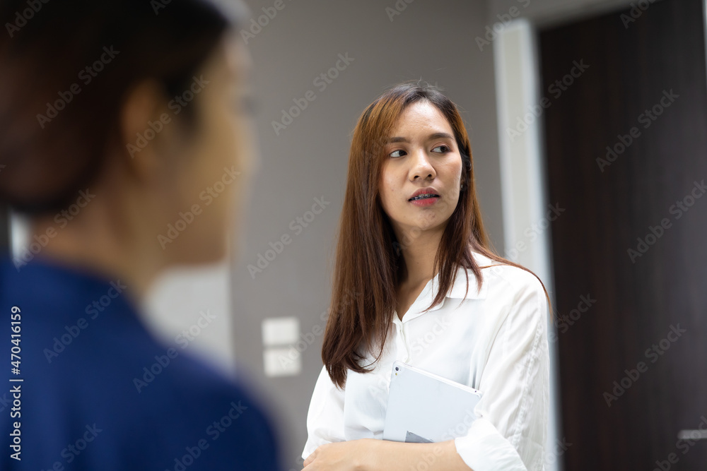 Portrait young asian businesswoman looking at the camera standing in modern office. Portrait young asian businesswoman looking at the camera standing in modern office.