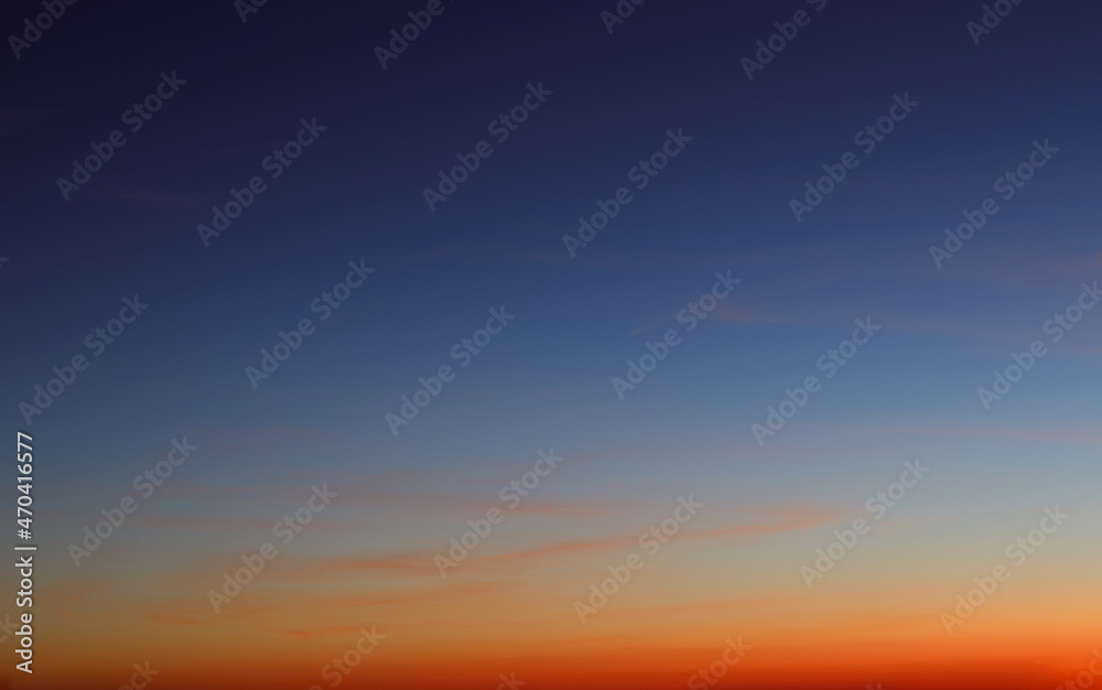 Heaven at early morning with copy space. Sunset, sunrise backdrop.Predawn clear sky with orange horizon and blue atmosphere. Smooth orange blue gradient of dawn sky.