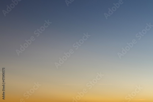 Heaven at early morning with copy space. Sunset, sunrise backdrop.Predawn clear sky with orange horizon and blue atmosphere. Smooth orange blue gradient of dawn sky.