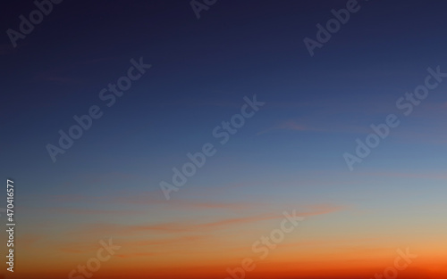 Heaven at early morning with copy space. Sunset  sunrise backdrop.Predawn clear sky with orange horizon and blue atmosphere. Smooth orange blue gradient of dawn sky.