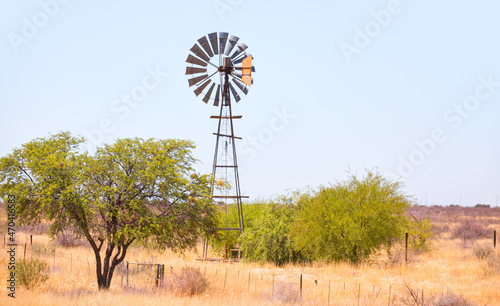 Old Windmill on a Farm at bright blue sky