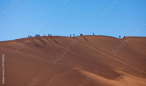 Dead Vlei in Namib desert, peoples climbing to top of dune, Namibia, Southern Africa landscape © muratart