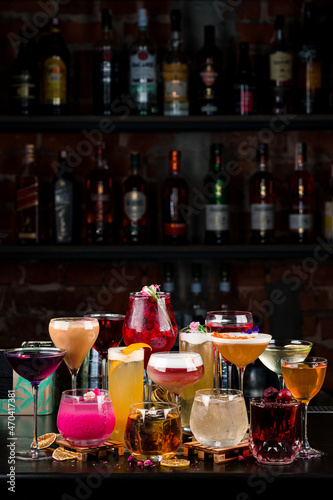 set cocktails on the bar counter against the background of a dark bar vertically
