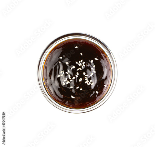 Teriyaki sauce with sesame seeds isolated on a white background.