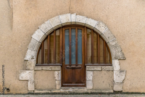 Antique door on a stone façade © serge