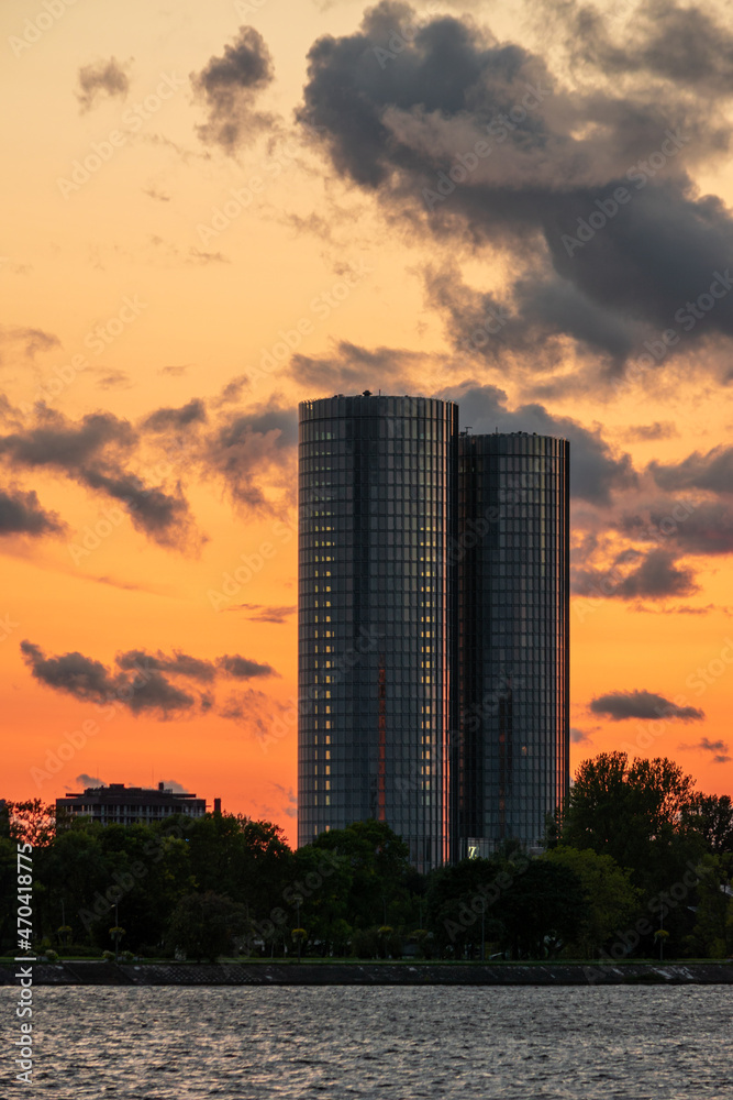 Magnificent sunset over the Daugava river in Riga, Latvia with Z towers and the Stone bridge in the background. Colorful clouds and warm skylight