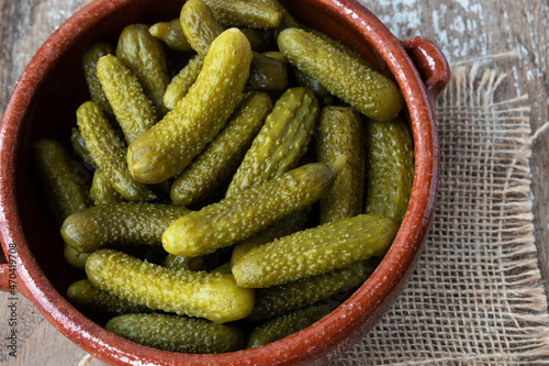 Pickled gherkins on rustic background