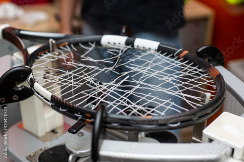 Process of stringing a tennis racket in a tennis shop, new tennis racket string, sport and leisure concept © Khaligo