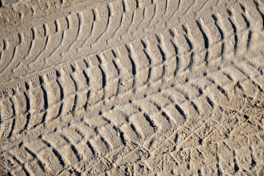 Natural sand stone texture background. Sand texture from heap of sand. Traces of the protectors of heavy industrial machinery on white sand. Background. Natural sand stone texture background. Sand texture from heap of sand. Traces of the protectors of heavy industrial machinery on white sand. Background.