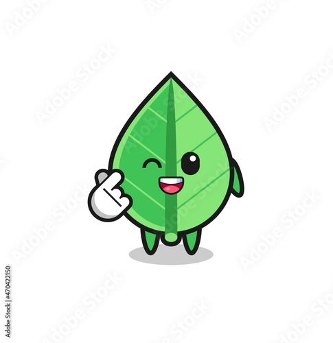 leaf character doing Korean finger heart