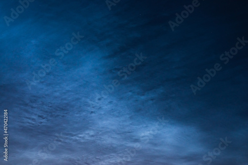Obraz na płótnie Noctilucent clouds close up on a summer night. Glowing clouds in the night sky. w salonie